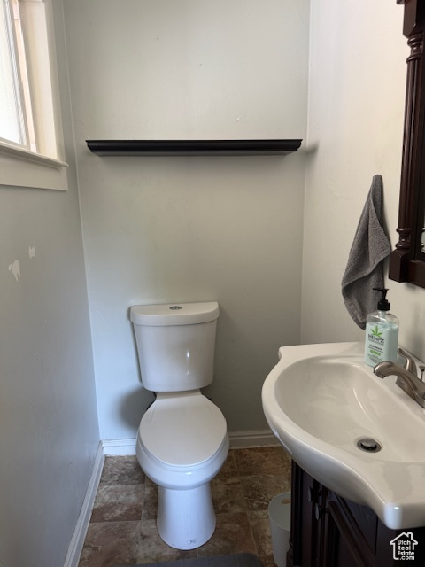 Half bathroom with vanity and toilet