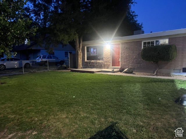 View of front of property with a front lawn and brick siding