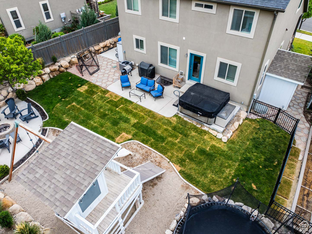 Rear view of property with an outdoor living space, a fenced backyard, a patio, stucco siding, and a shingled roof