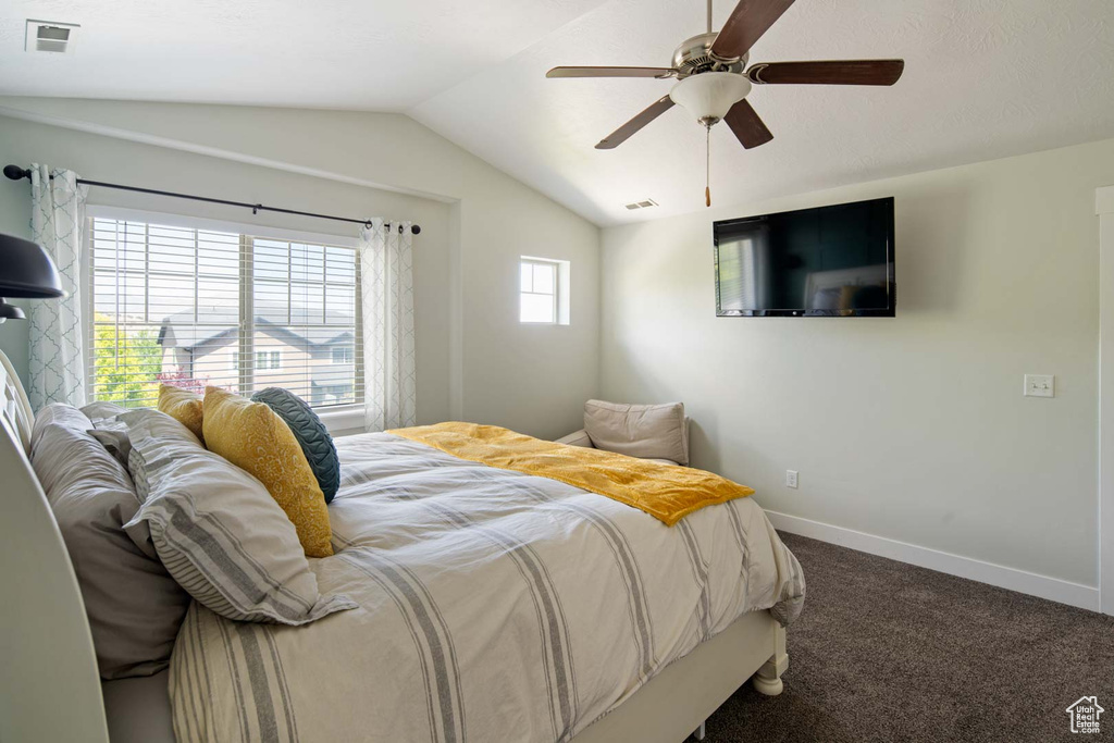 Bedroom featuring visible vents, baseboards, a ceiling fan, carpet, and vaulted ceiling