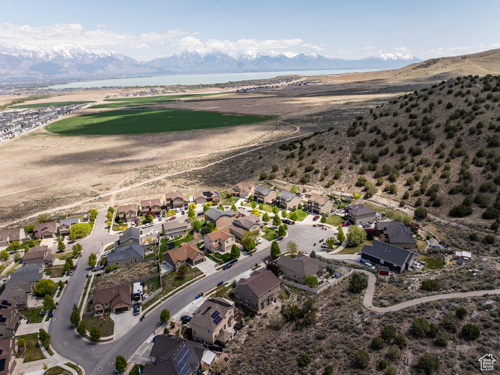 Birds eye view of property featuring a water and mountain view and a residential view
