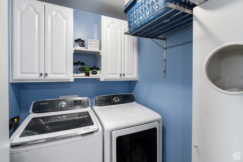 Clothes washing area featuring washing machine and clothes dryer