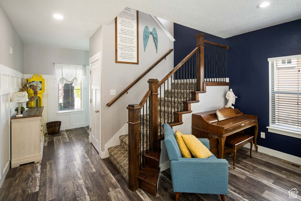 Stairway featuring recessed lighting, baseboards, visible vents, and wood finished floors