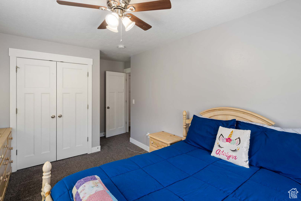 Bedroom featuring a closet, carpet flooring, baseboards, and ceiling fan