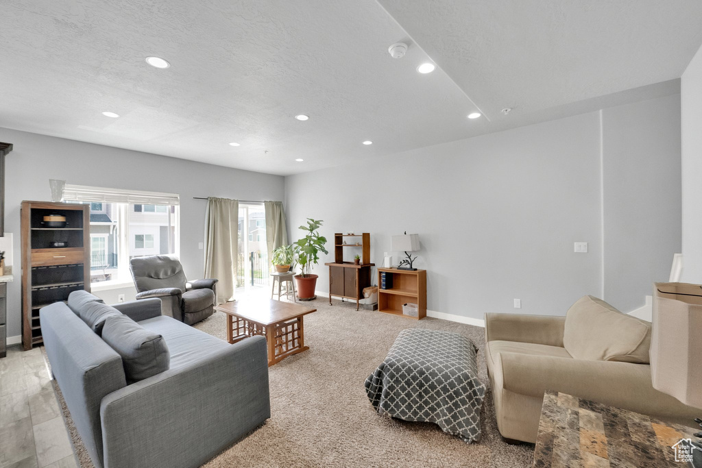 Living room with baseboards, light carpet, and recessed lighting
