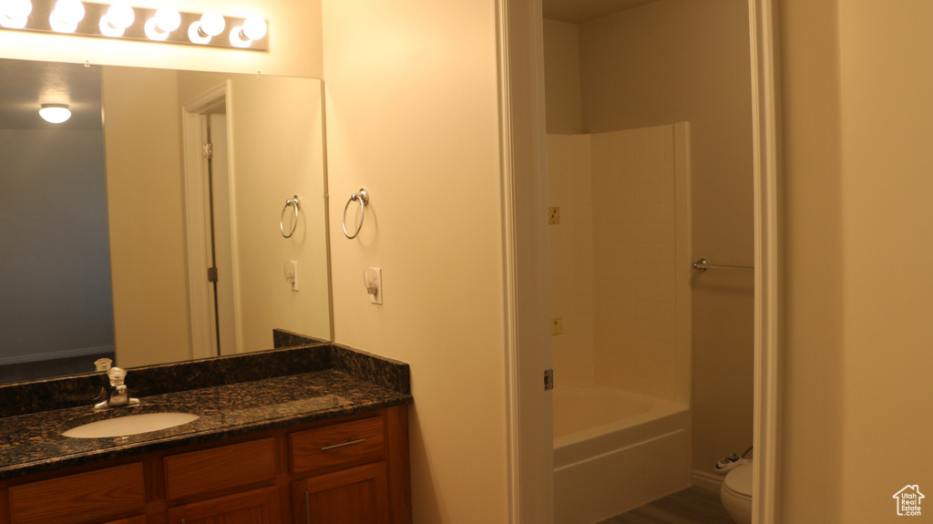 Full bath with vanity, bathtub / shower combination, and toilet