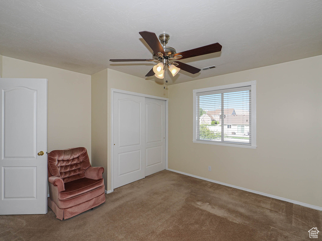 Unfurnished bedroom featuring ceiling fan, visible vents, baseboards, a closet, and carpet flooring