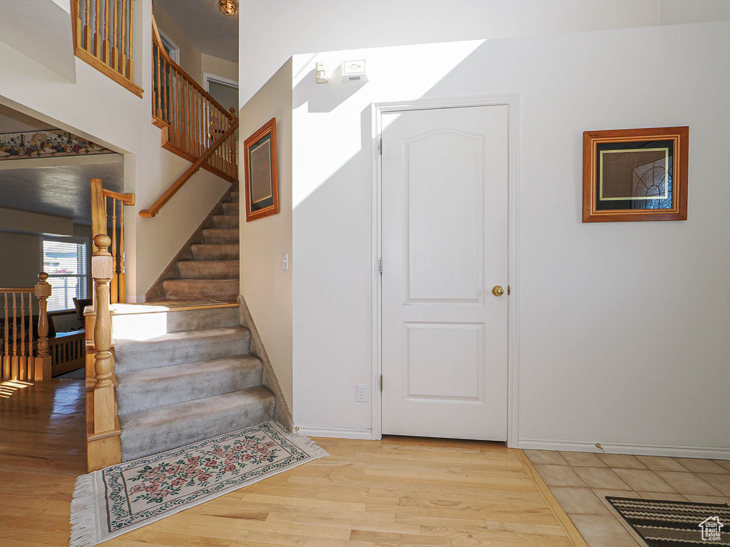 Staircase featuring baseboards and wood finished floors
