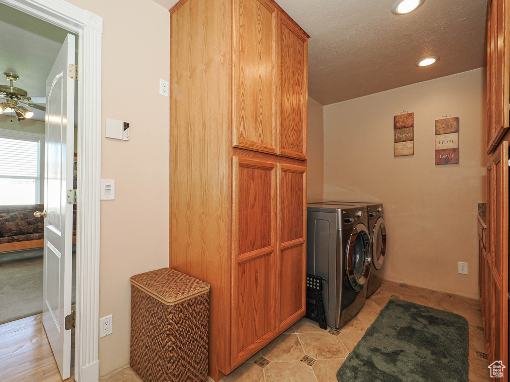 Laundry area featuring cabinet space, recessed lighting, ceiling fan, and washer and clothes dryer