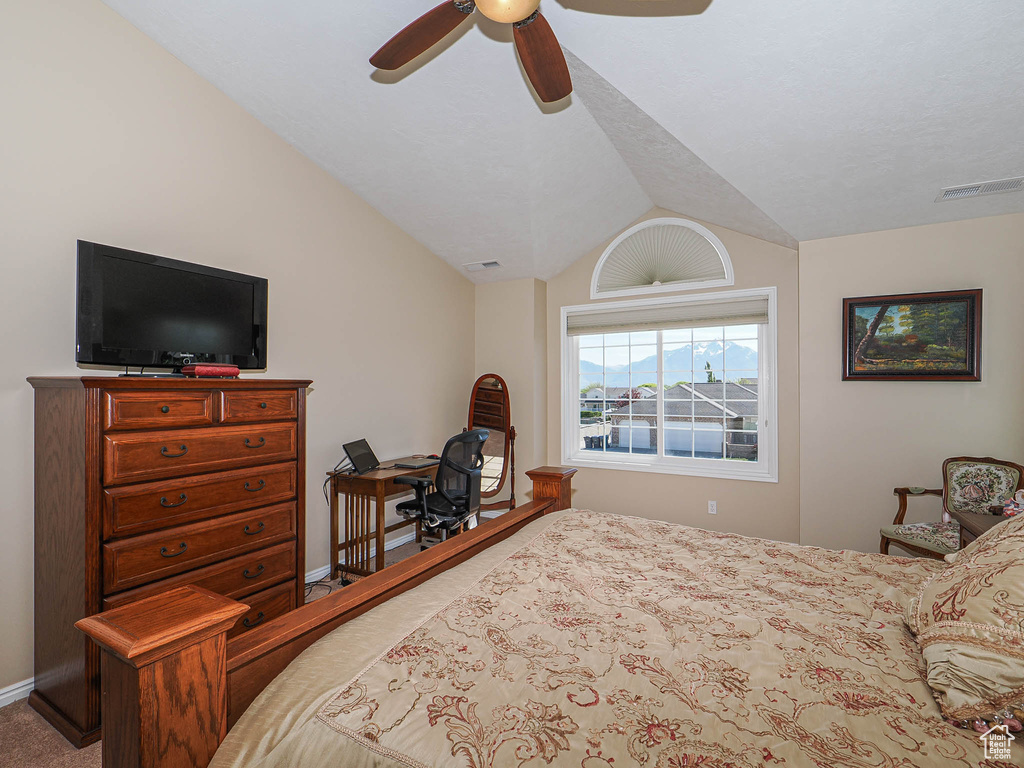 Bedroom featuring carpet floors, visible vents, baseboards, ceiling fan, and vaulted ceiling