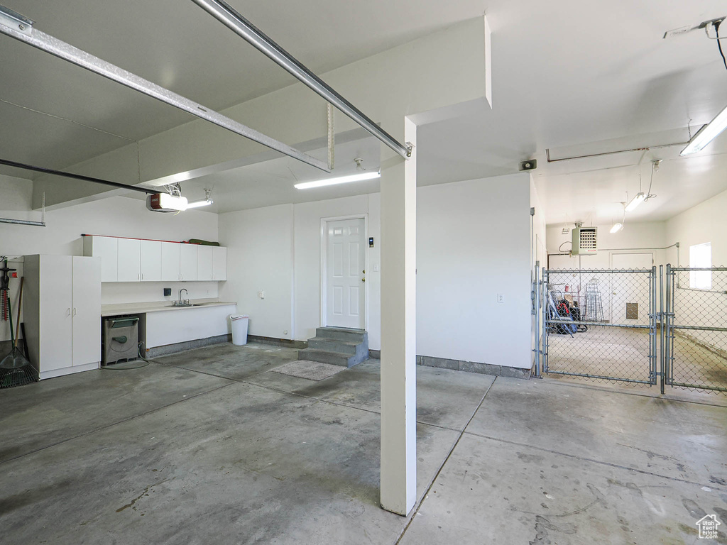 Garage with a sink and a garage door opener