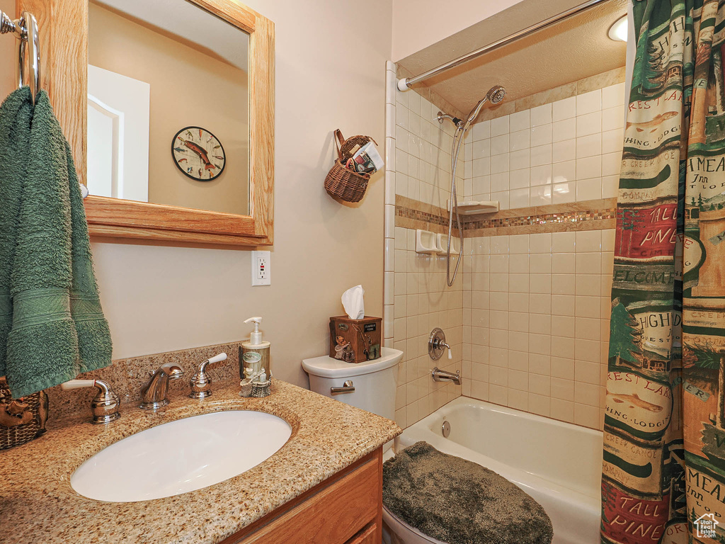 Full bath with vanity, toilet, and shower / tub combo
