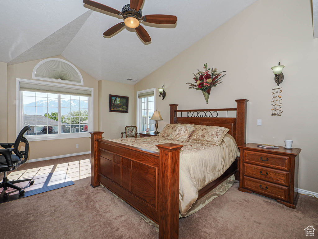 Bedroom with a ceiling fan, visible vents, vaulted ceiling, carpet floors, and baseboards