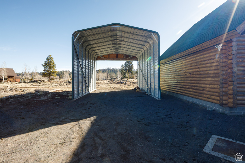 View of vehicle parking featuring a carport and driveway