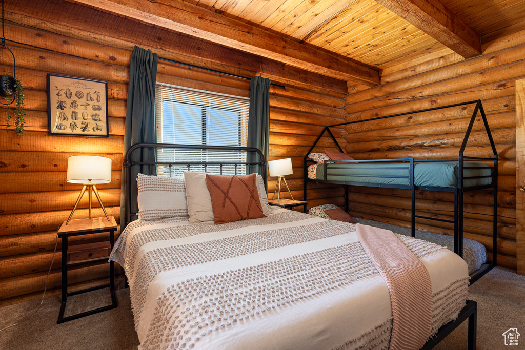 Bedroom with wooden ceiling, carpet floors, and beam ceiling