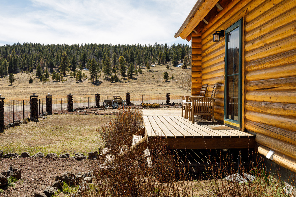 View of yard with fence and a wooden deck