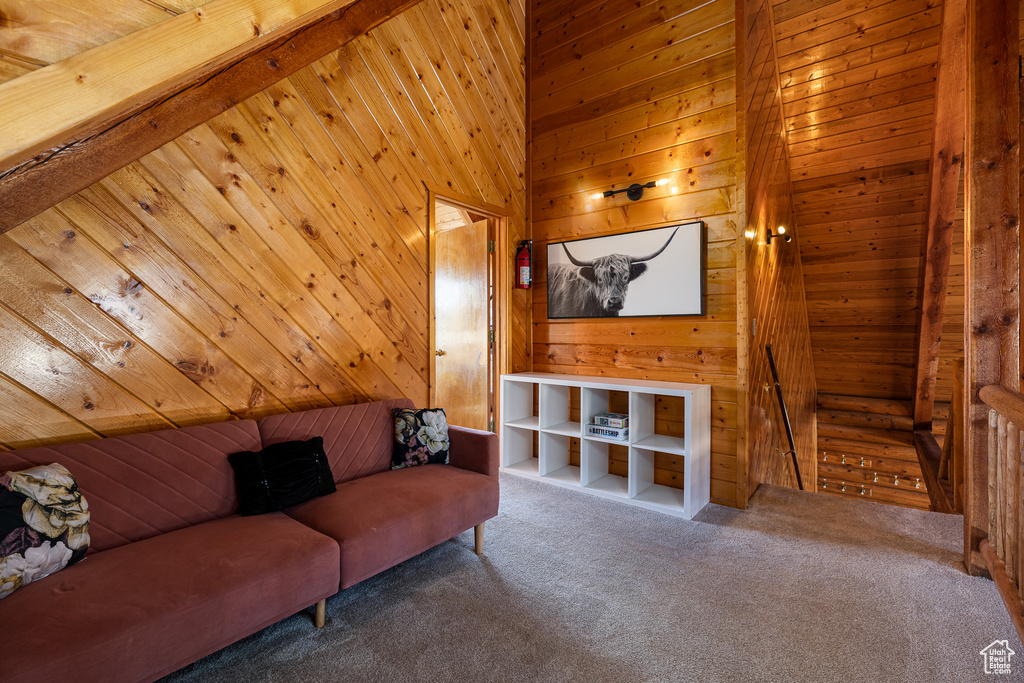 Living room with carpet flooring and wooden walls