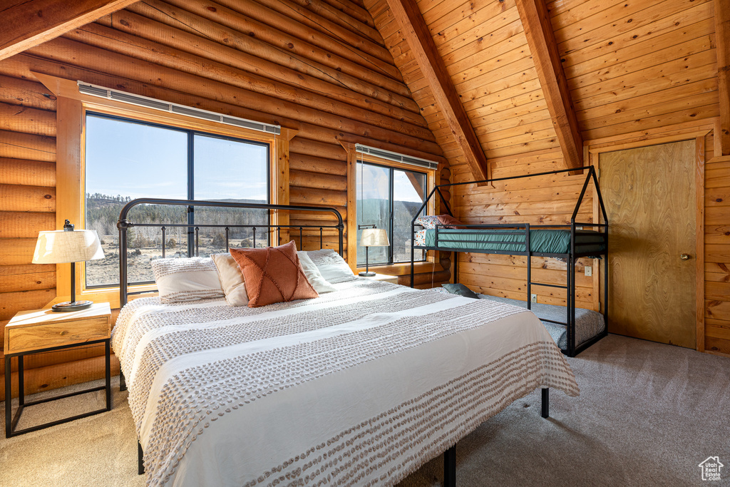 Bedroom featuring carpet floors, wood ceiling, lofted ceiling with beams, and log walls