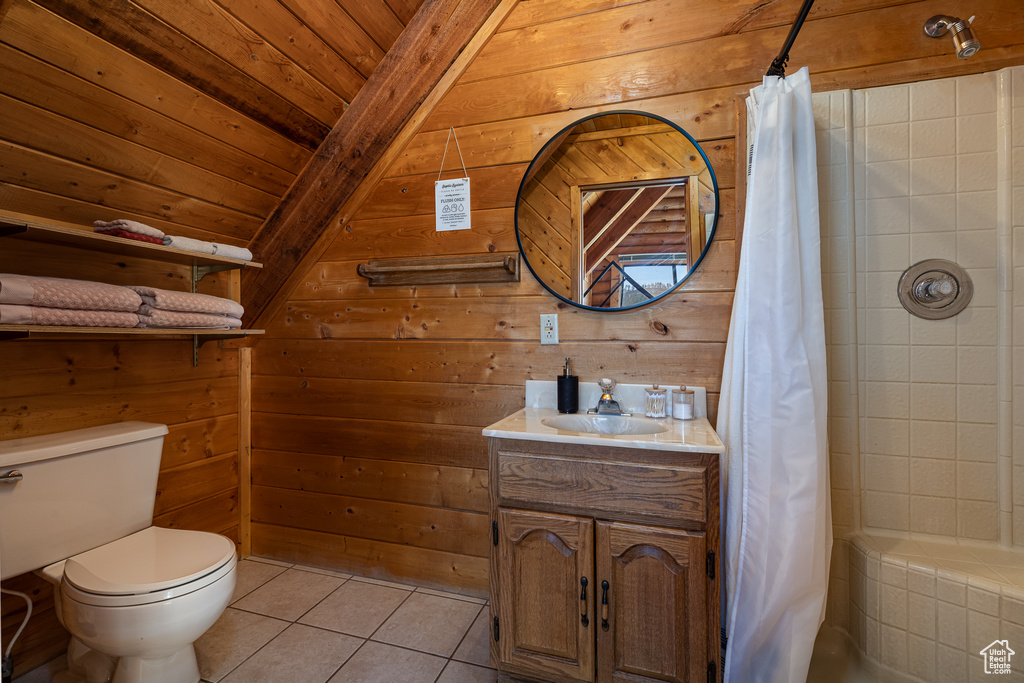 Bathroom featuring tile patterned flooring, wood walls, toilet, beamed ceiling, and wood ceiling