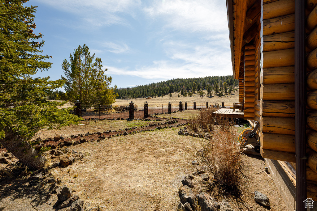 View of yard with fence and a rural view