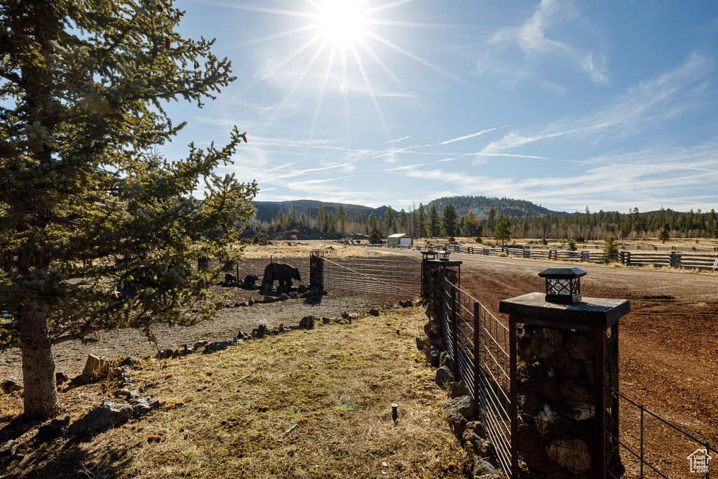 Exterior space featuring a rural view, fence, and a mountain view