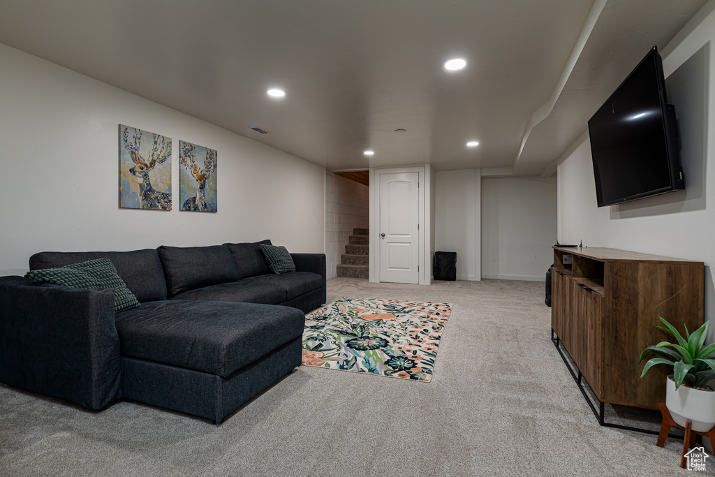 Living room with recessed lighting, baseboards, visible vents, and light carpet