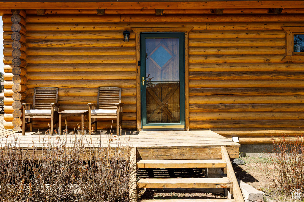 View of exterior entry featuring log siding