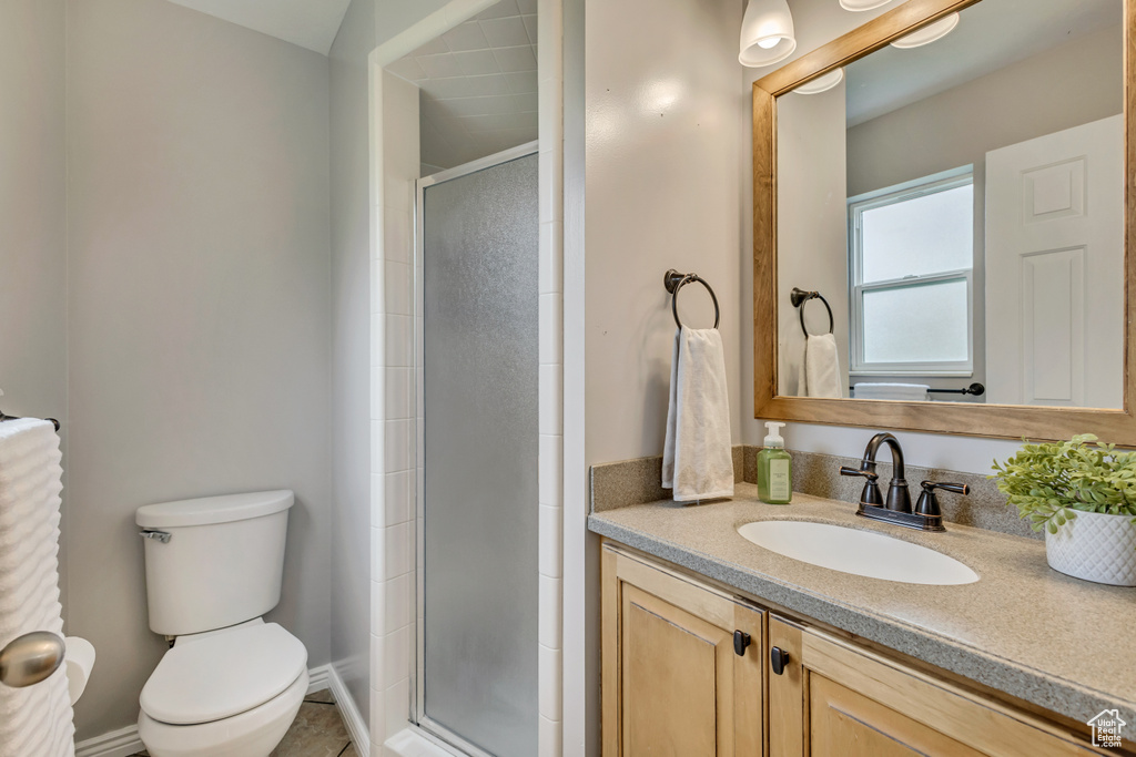 Full bath with vanity, toilet, and a shower stall