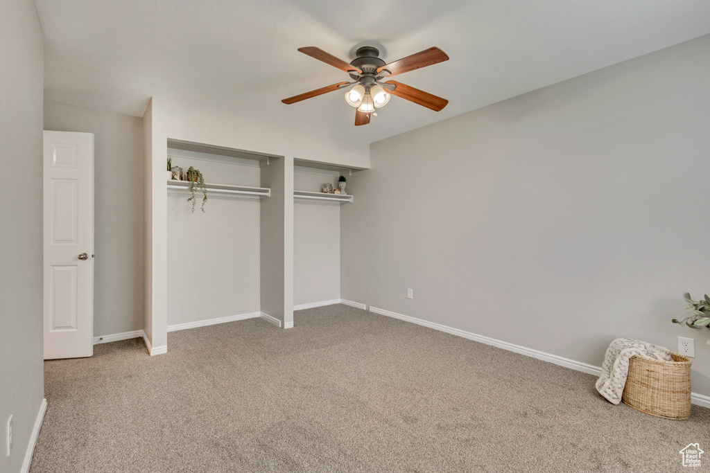 Unfurnished bedroom with carpet flooring, a ceiling fan, baseboards, and a closet