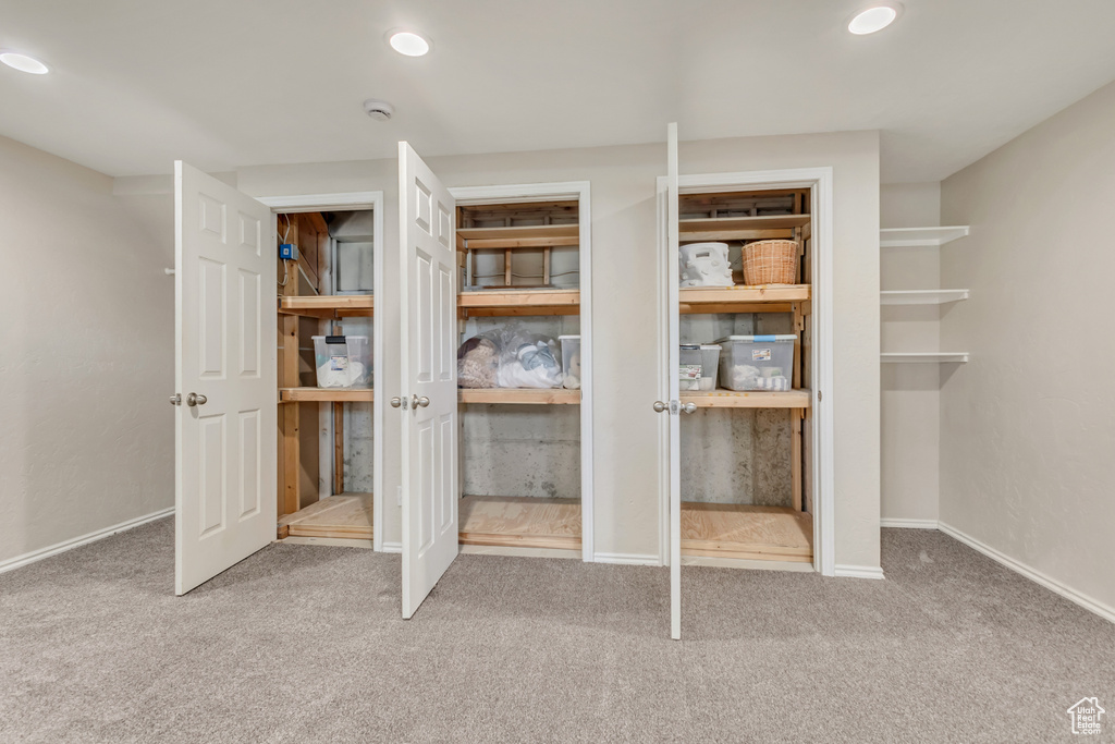 Unfurnished bedroom featuring two closets, recessed lighting, baseboards, and carpet