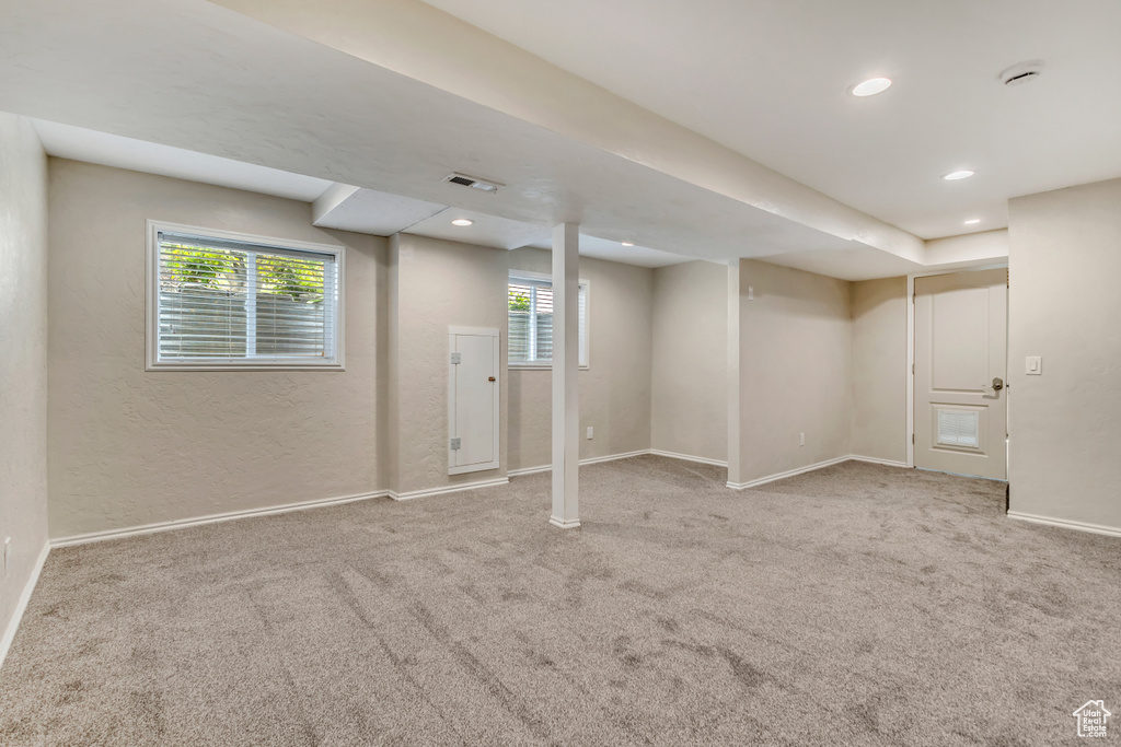 Basement featuring baseboards, carpet, and recessed lighting
