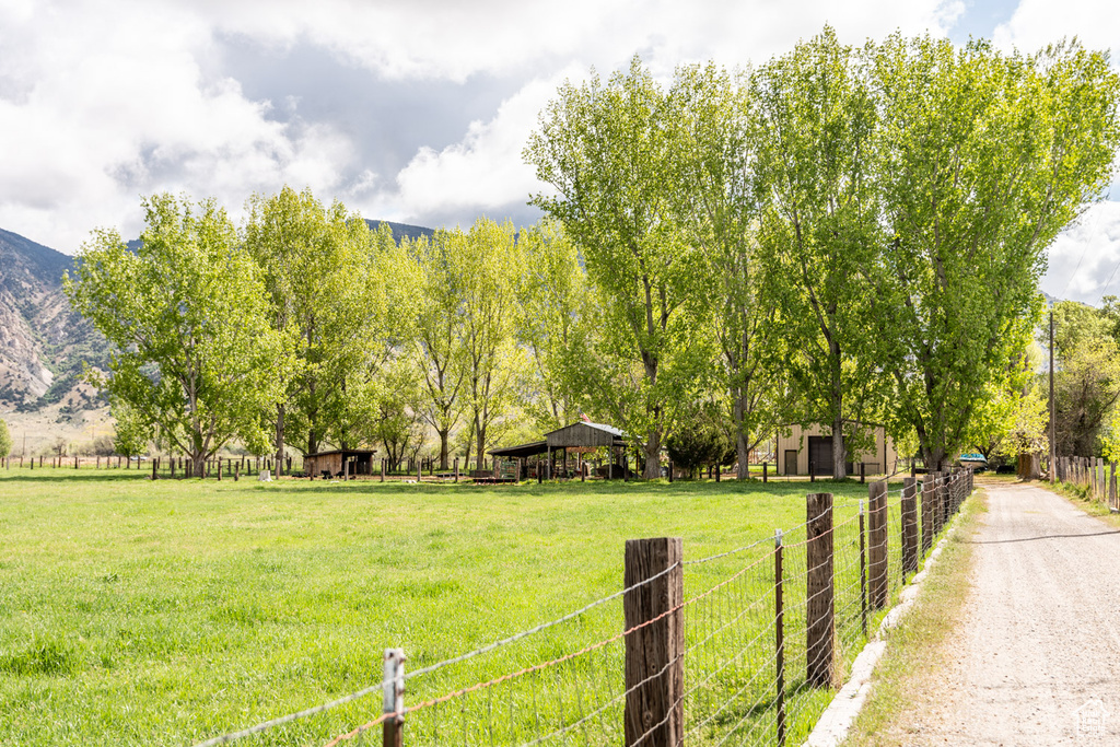 View of yard with a mountain view and fence