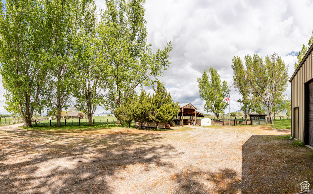 View of yard featuring a pole building, fence, and an outdoor structure