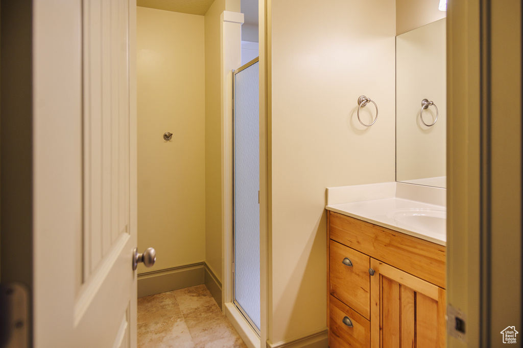 Full bath featuring a shower stall and vanity