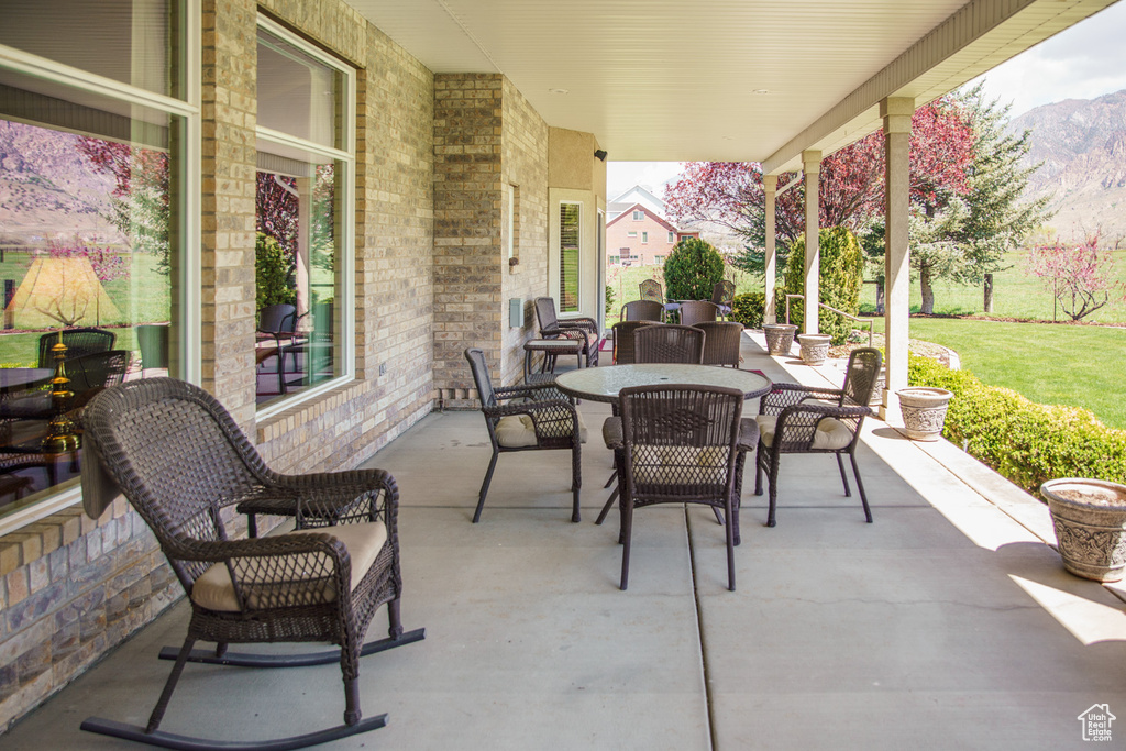 View of patio / terrace featuring a mountain view and outdoor dining space