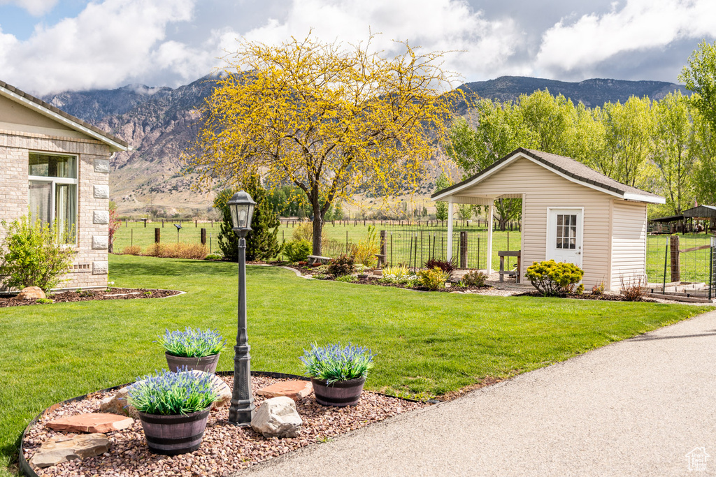 View of yard with fence and a mountain view