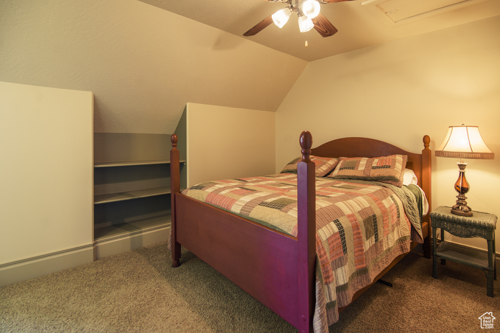 Bedroom with carpet flooring, ceiling fan, and lofted ceiling