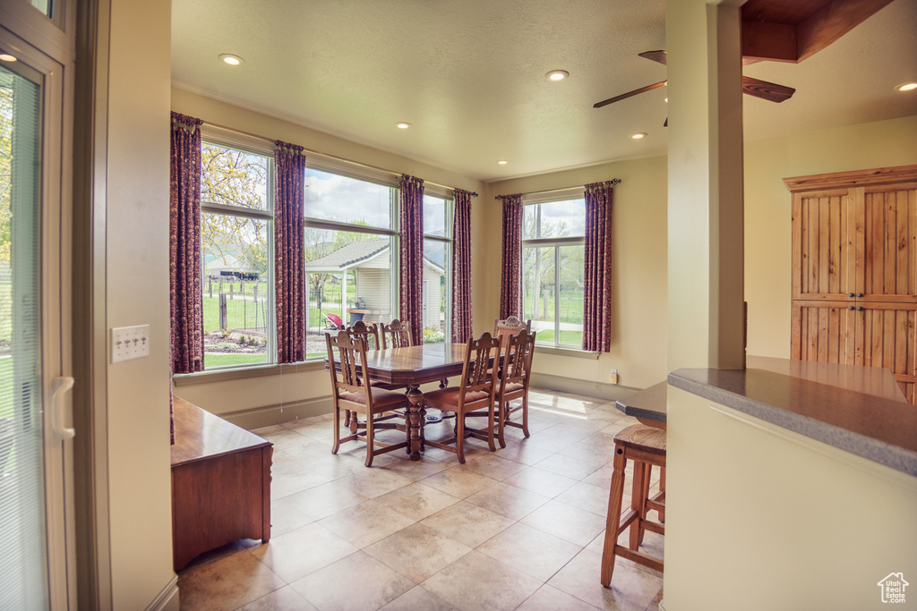 Dining space with light tile patterned floors, baseboards, a ceiling fan, and recessed lighting
