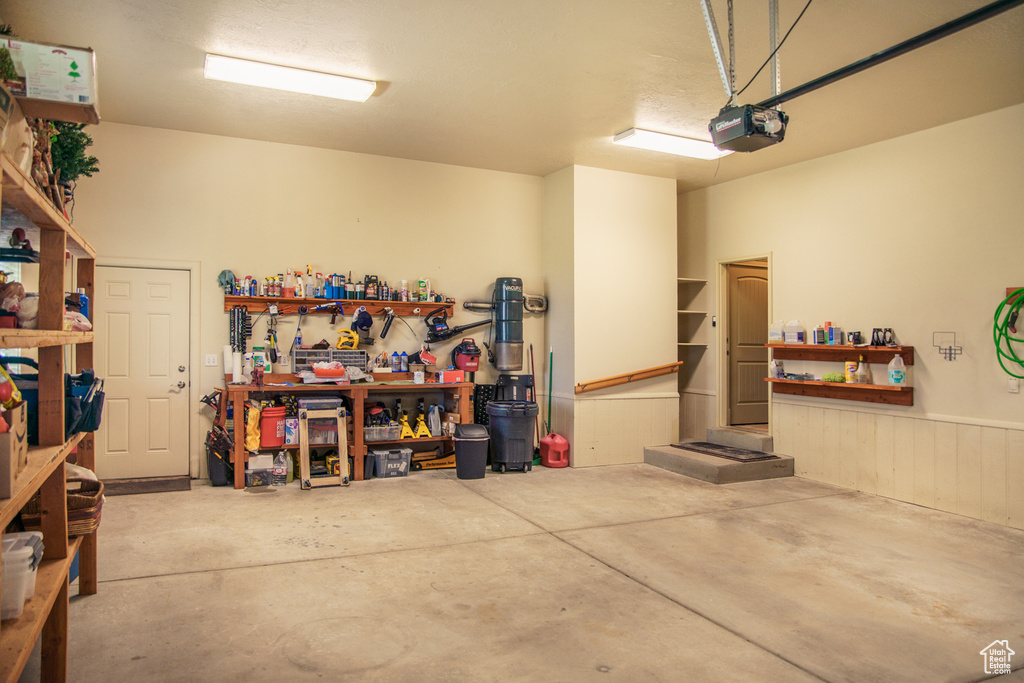 Garage featuring a workshop area and a garage door opener