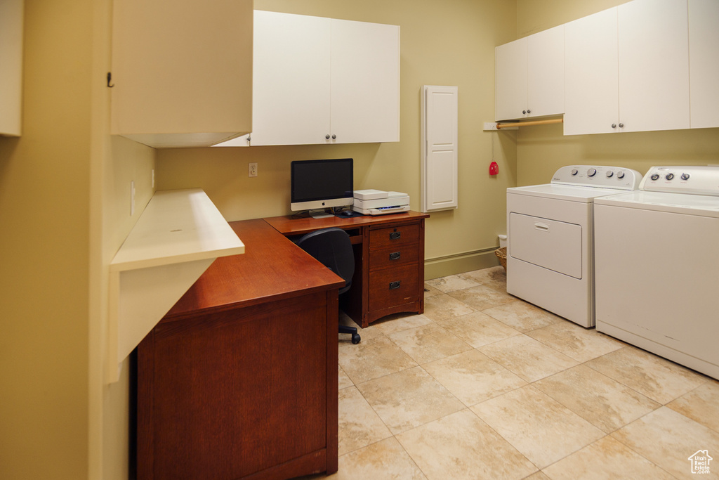 Washroom featuring washing machine and dryer and cabinet space
