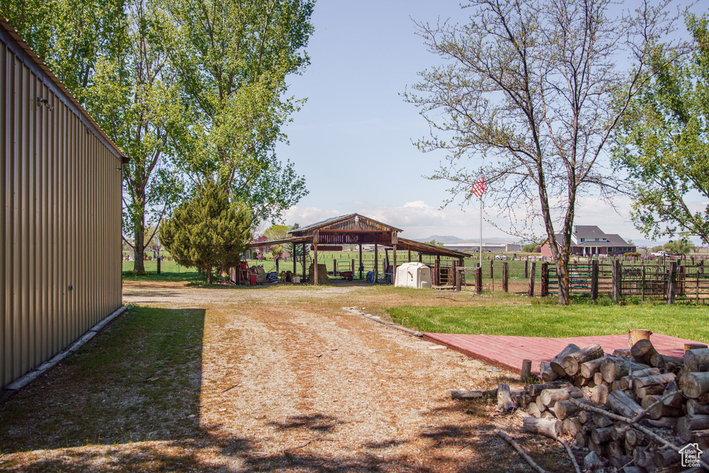 View of yard with a storage shed, fence, and an outbuilding