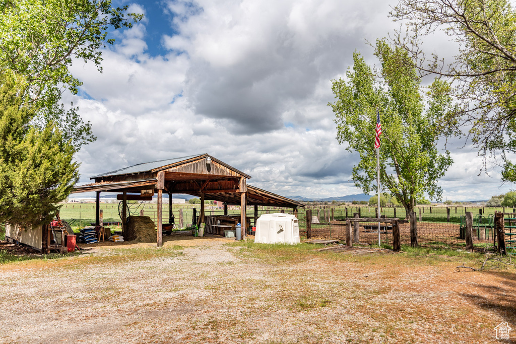 View of yard featuring fence and an outbuilding
