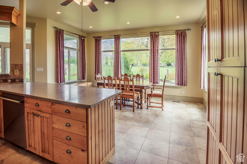 Kitchen featuring recessed lighting, a peninsula, ceiling fan, and stainless steel dishwasher