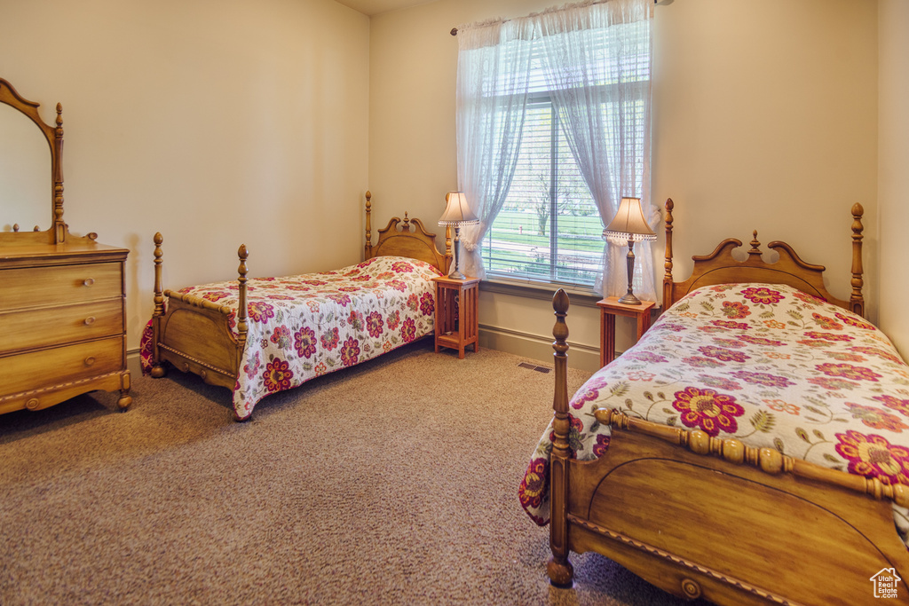 Carpeted bedroom featuring baseboards