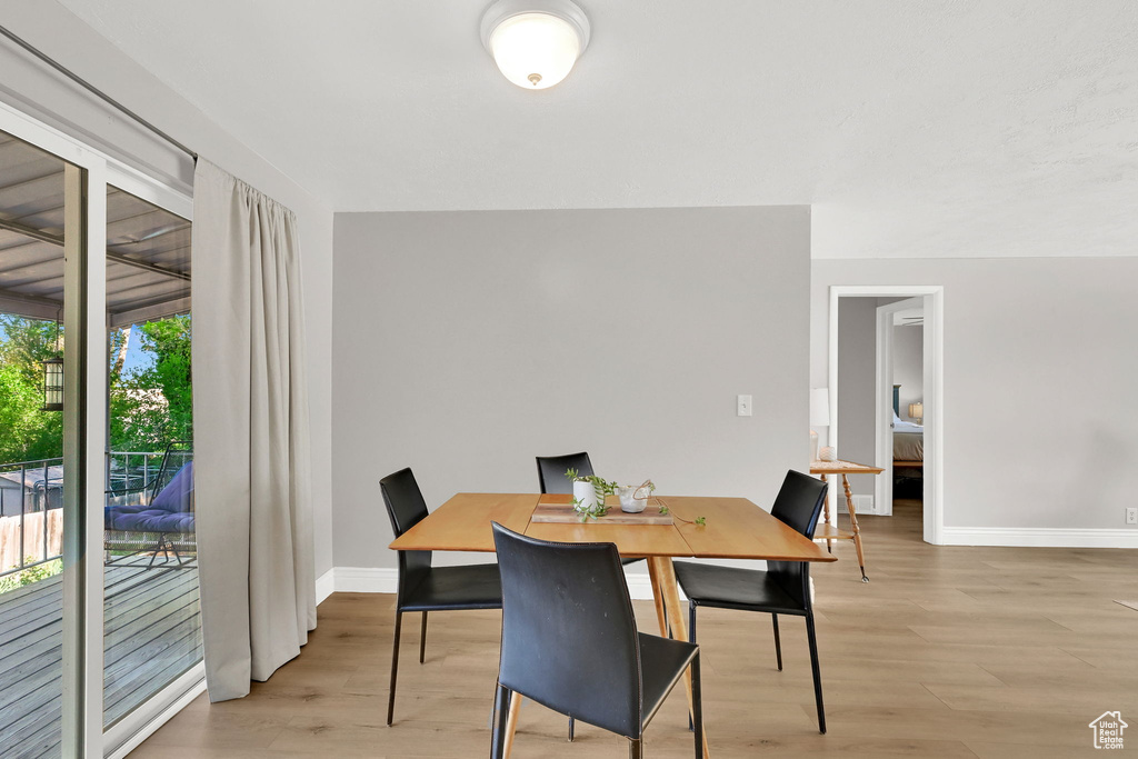 Dining space with baseboards and light wood finished floors