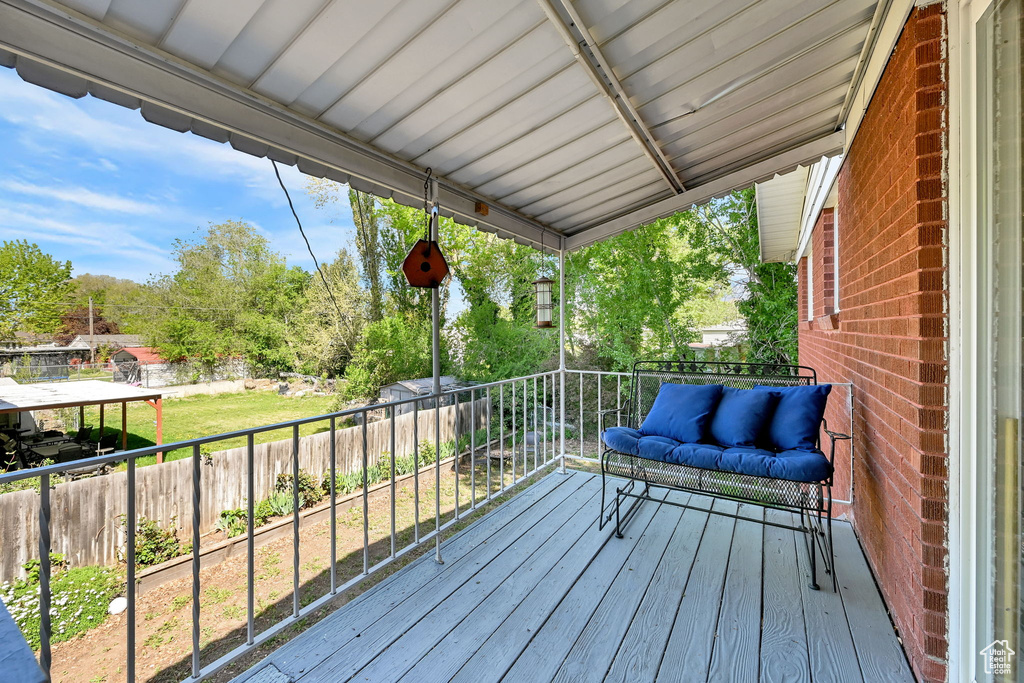 Wooden deck with a fenced backyard