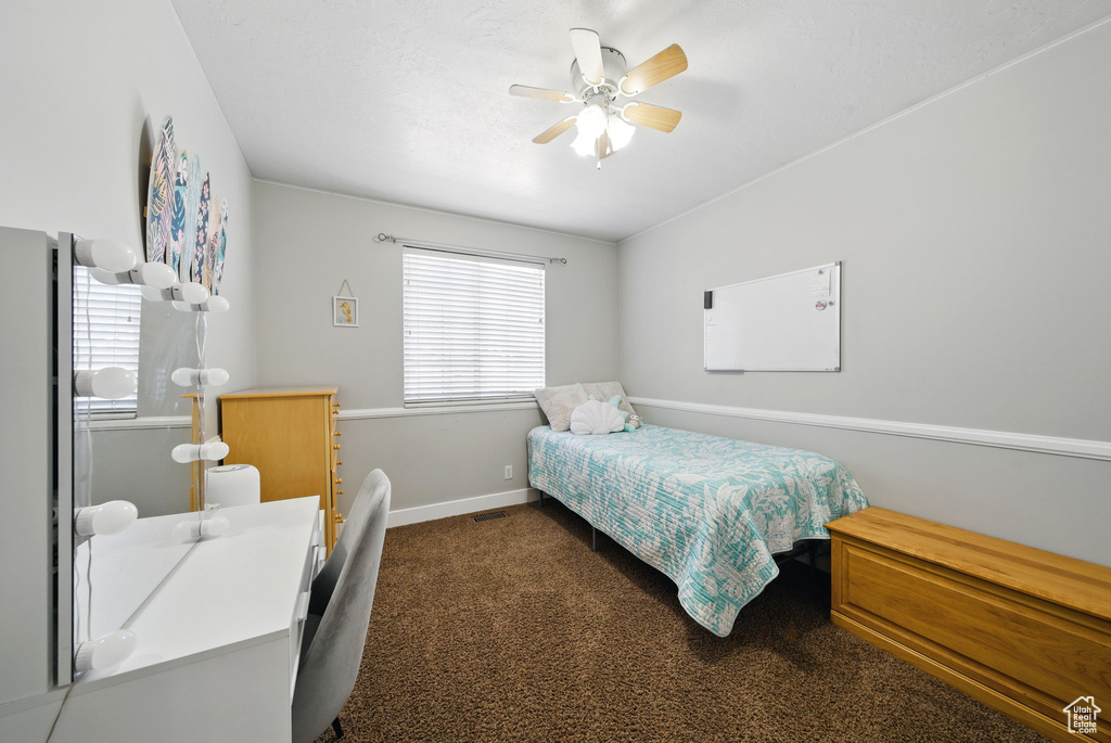 Carpeted bedroom with baseboards and ceiling fan