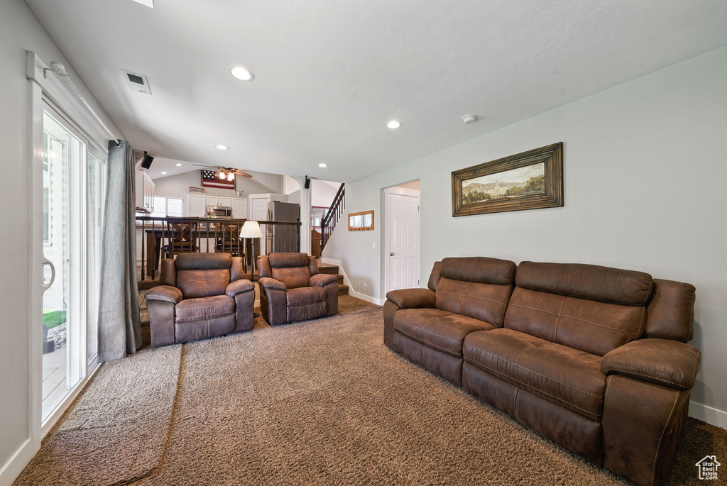 Living room with carpet floors, stairs, recessed lighting, baseboards, and visible vents