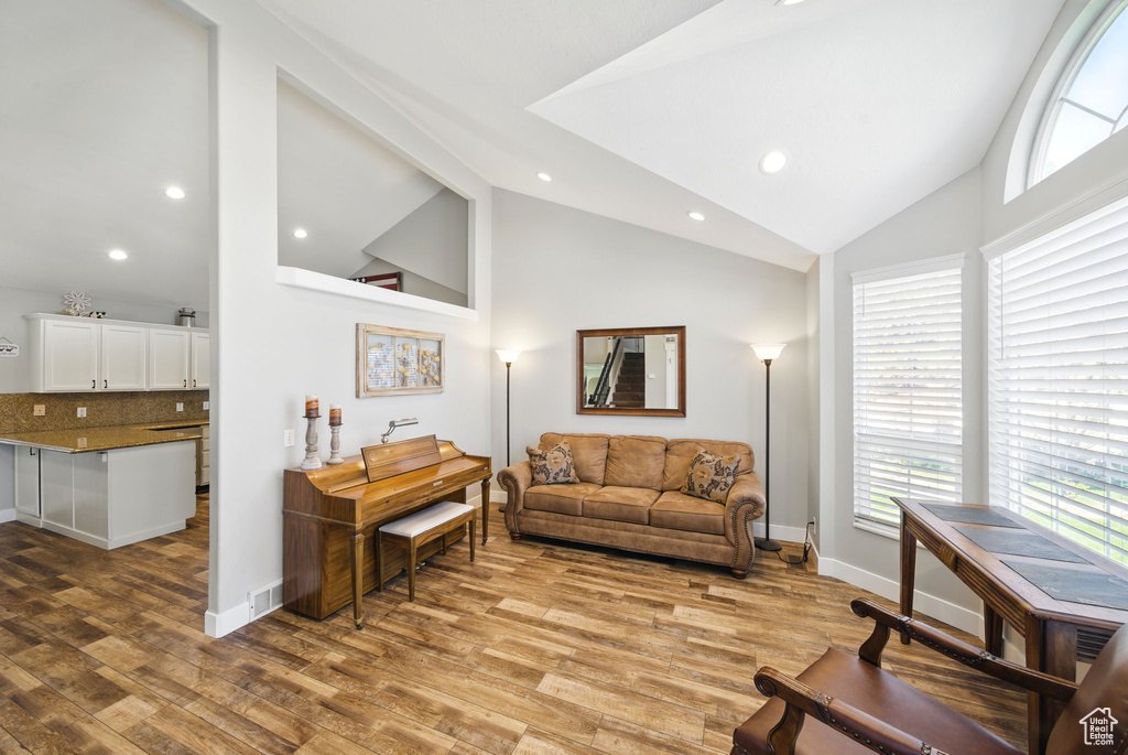 Living area with recessed lighting, plenty of natural light, and light wood finished floors