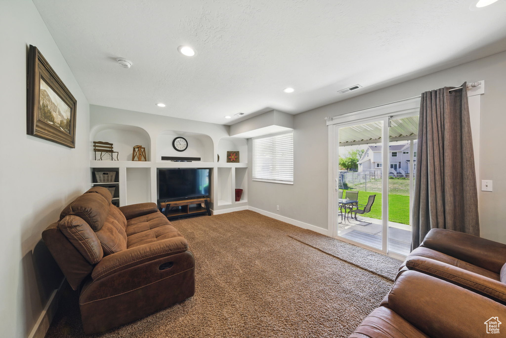 Living area with built in features, baseboards, carpet, and recessed lighting